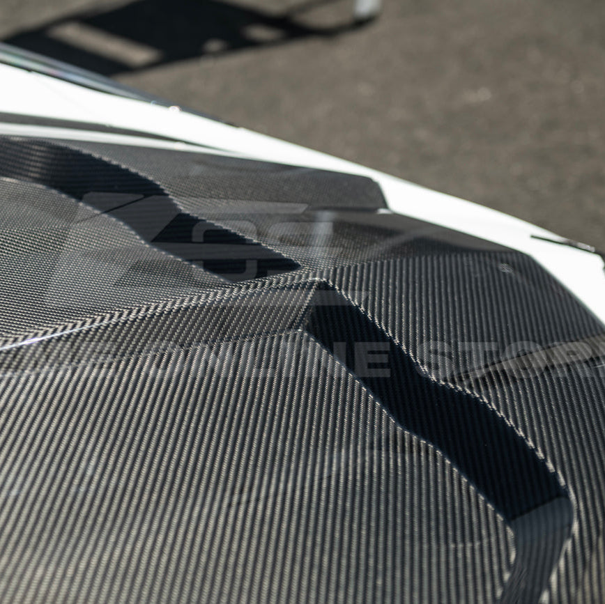 Close-up image of the Corvette C8 EOS Performance Track Style Double-Sided Dry Carbon Fiber Front Hood showing the premium dry carbon weave, lightweight construction, and aggressive aerodynamic design that enhances both performance and style.