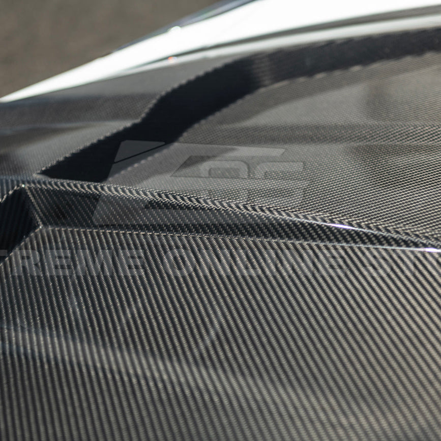 Close-up image of the Corvette C8 EOS Performance Track Style Double-Sided Dry Carbon Fiber Front Hood showing the premium dry carbon weave, lightweight construction, and aggressive aerodynamic design that enhances both performance and style.