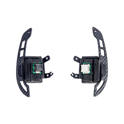 Close-up view of Corvette C8 steering wheel magnetic paddle shifters installed, showing premium aluminum finish and sporty design.